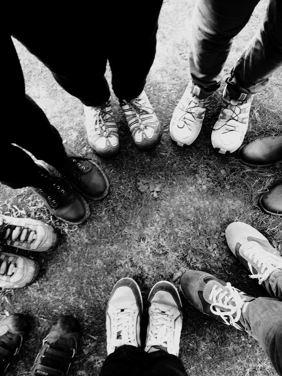 low section, person, shoe, standing, men, togetherness, lifestyles, personal perspective, leisure activity, high angle view, street, friendship, footwear, road, bonding, footpath, human foot, day, friend