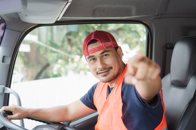 Portrait of young man sitting in car