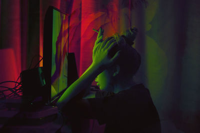 Portrait of young man standing at home