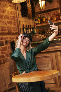 Portrait of smiling young woman using mobile phone