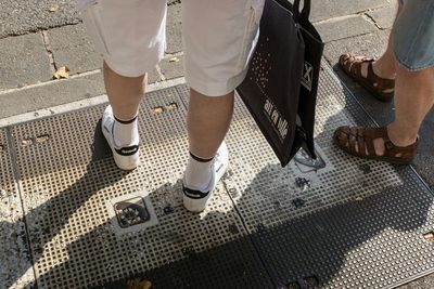 Low section of woman standing on tiled floor