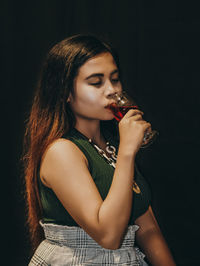 Close-up of a beautiful young woman drinking