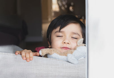 Portrait of cute boy sleeping on bed at home