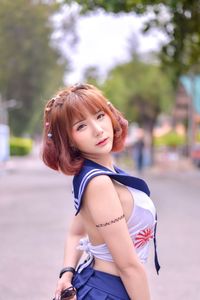 Portrait of redhead woman standing on road