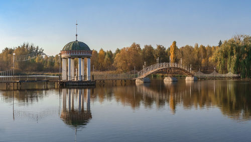 Gazebo in the middle of the lake on a sunny autumn evening in the village of ivanki,  ukraine