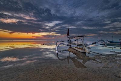 Scenic view of beach against sky during sunset