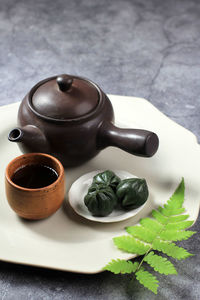 Green mugwort kkultteok is ball shaped rice cake filled with honey and sesame syrup