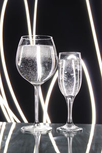 Close-up of wine glass against black background