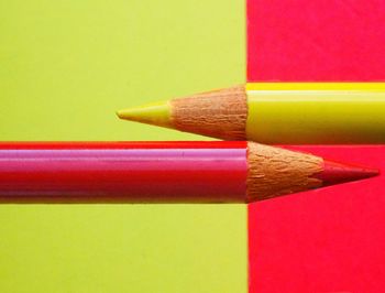 Close-up of colorful pencils against colored background