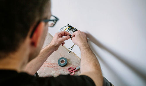 Portrait of man working on finger