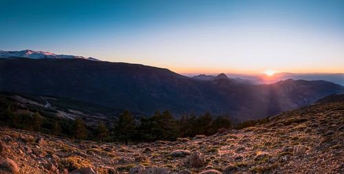 Scenic view of mountains against sky during sunset