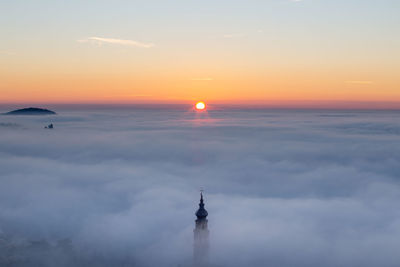 Scenic view of building against sky during sunset