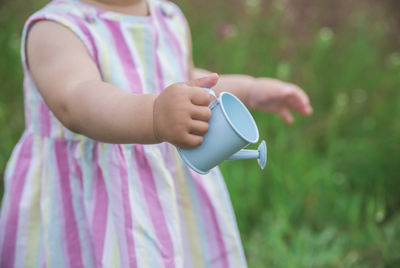 Midsection of woman holding coffee cup