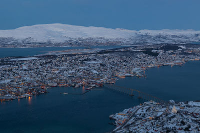 High angle view of river in town against sky during winter