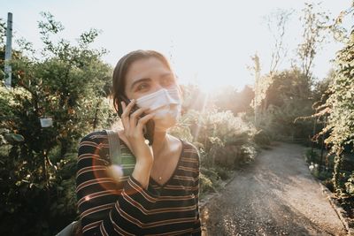 Portrait of young woman drinking outdoors