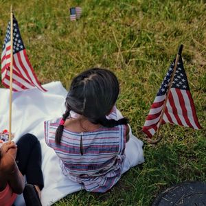 High angle view of girls with american flags on grass