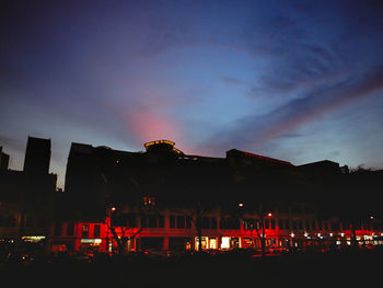 Illuminated city against sky at night