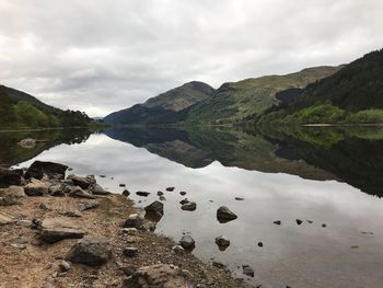 Scenic view of lake and mountains against sky