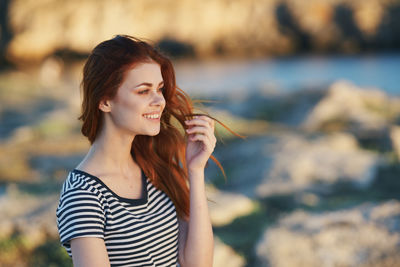 Smiling young woman looking away outdoors