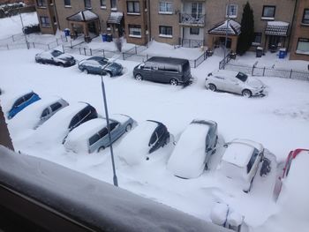 High angle view of snow covered cars in city