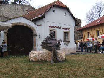 Statue outside house against building