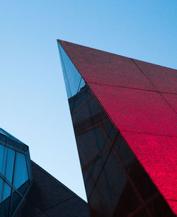 Low angle view of modern building against clear blue sky