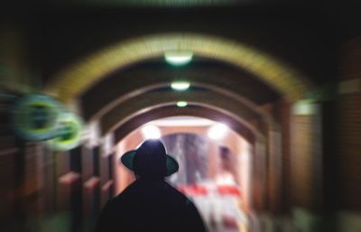 Defocused image of man photographing illuminated