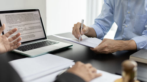 Midsection of businessman working at office