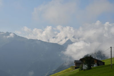 Houses on mountain against sky