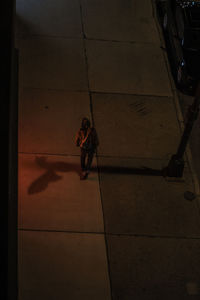 High angle view of woman walking on tiled floor