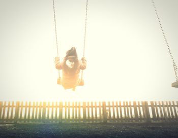 Low angle view of swing against clear sky