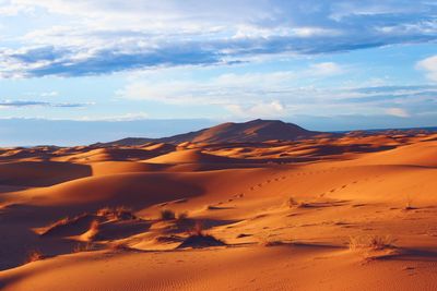 Idyllic shot of sand dunes in desert against sky