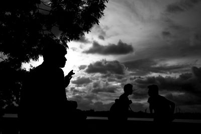 Silhouette of statue against sunset sky