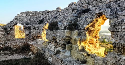 Low angle view of rock formation against sky