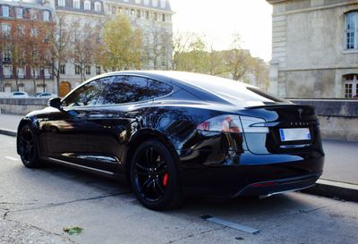 Car parked on street against buildings in city