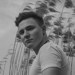 Portrait of young man against sky