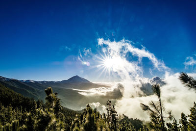 Scenic view of mountains against blue sky