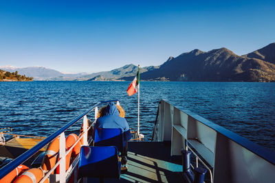 Commuter sitting on a boat while crossing lake maggiore