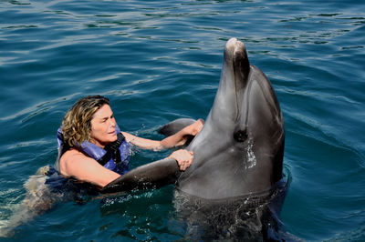 Picture of female  held by a dolphin