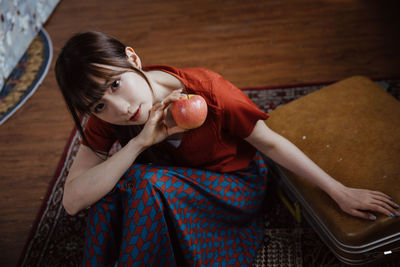 Portrait of young woman drinking coffee at home