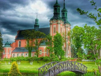 Built structure on landscape against cloudy sky