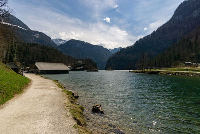 Scenic view of lake by mountains against sky