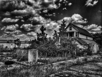 Houses against cloudy sky