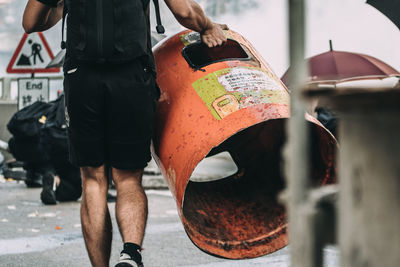 Low section of man standing on street