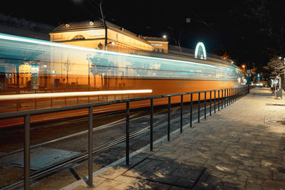 Train on railroad station platform at night