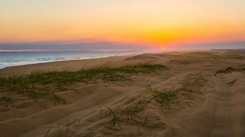 Scenic view of beach against sky during sunset