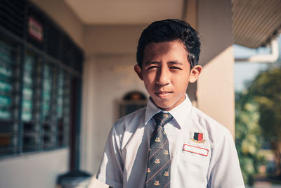 Portrait of boy wearing school uniform