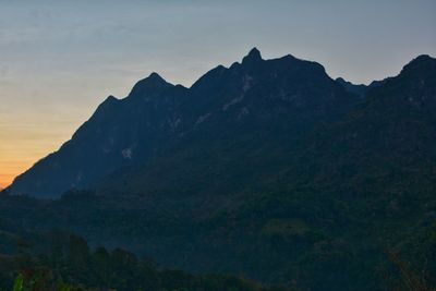 Scenic view of silhouette mountains against sky