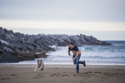 Woman with dog on beach