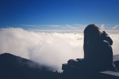 Silhouette of woman against sky